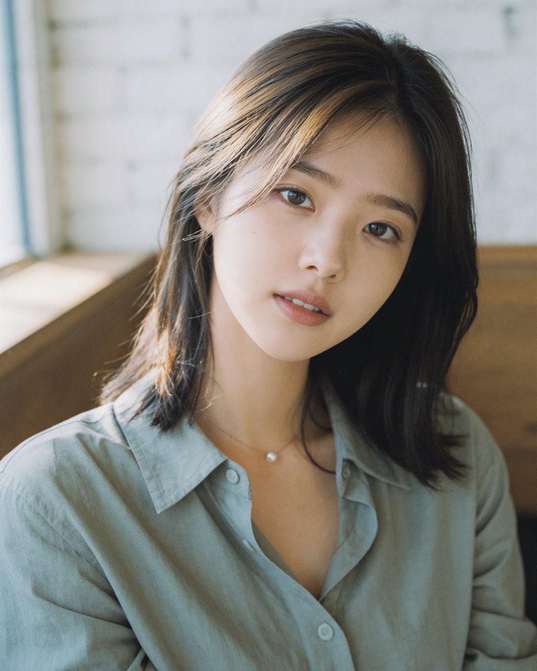A close-up of SEOA in a sage green shirt